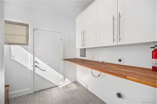 clothes washing area featuring cabinet space, baseboards, washer hookup, and hookup for an electric dryer