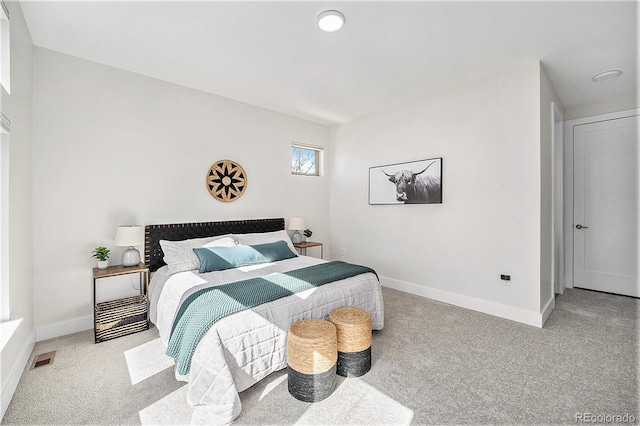 carpeted bedroom featuring visible vents and baseboards