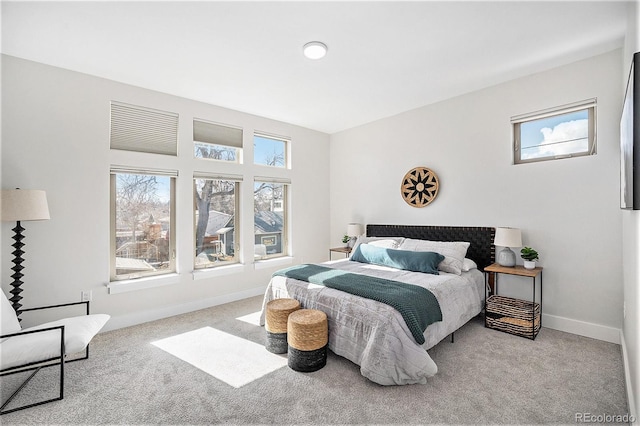 carpeted bedroom featuring baseboards