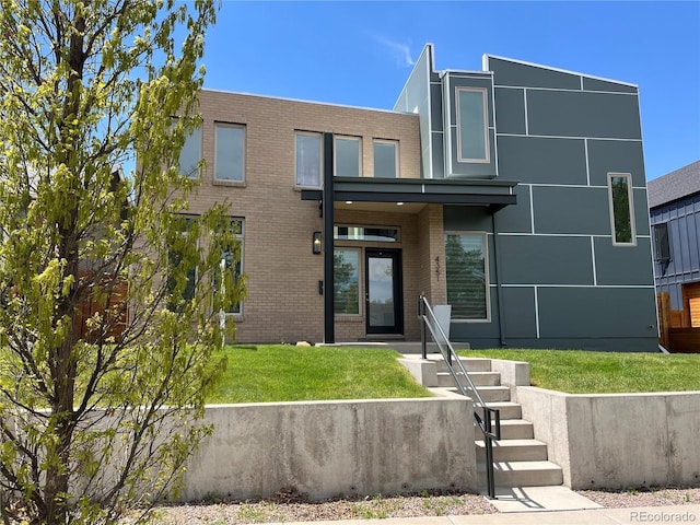 4351 Yates St, Denver, CO 80212 - view of front facade featuring brick siding and a front yard