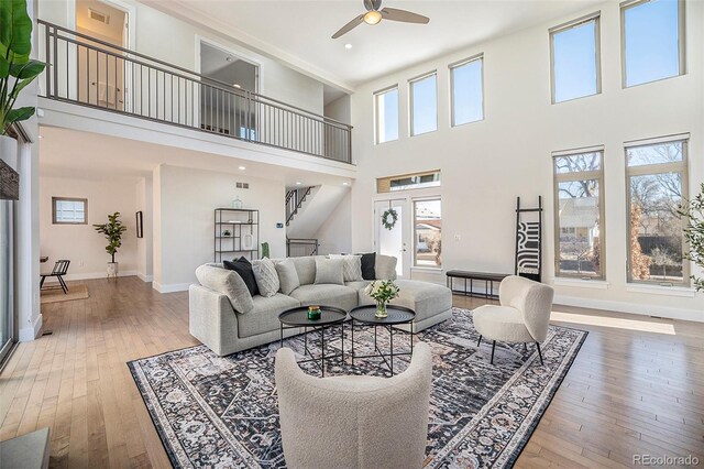 4351 Yates St, Denver, CO 80212 - living room featuring ceiling fan, a high ceiling, healthy amount of natural light, and hardwood / wood-style floors