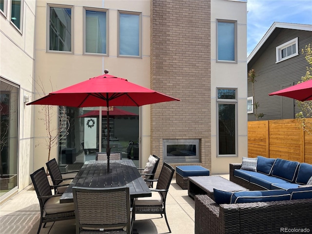4351 Yates St, Denver, CO 80212 - view of patio featuring an outdoor living space with a fireplace, fence, and outdoor dining space