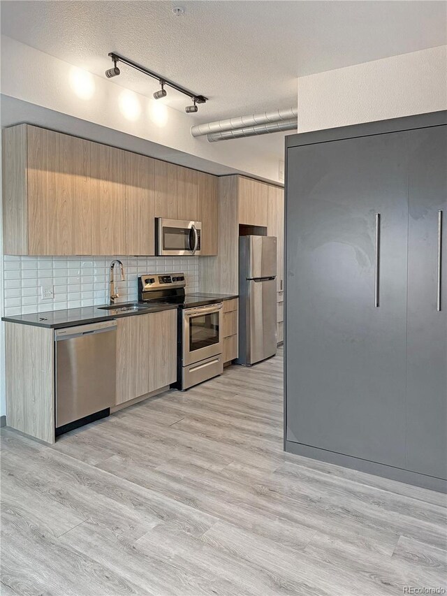 603 Inca St Unit 429, Denver, CO 80204 - kitchen with appliances with stainless steel finishes, modern cabinets, light brown cabinets, and a sink