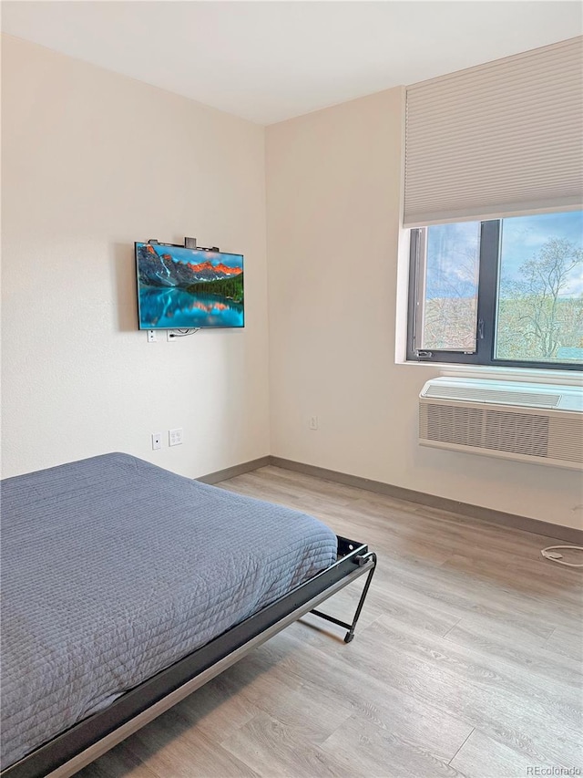 603 Inca St Unit 429, Denver, CO 80204 - bedroom with light wood-style floors, radiator, and baseboards