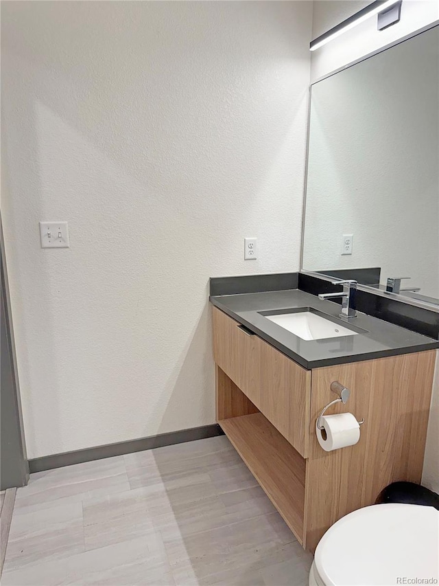 603 Inca St Unit 429, Denver, CO 80204 - bathroom with vanity, baseboards, and toilet