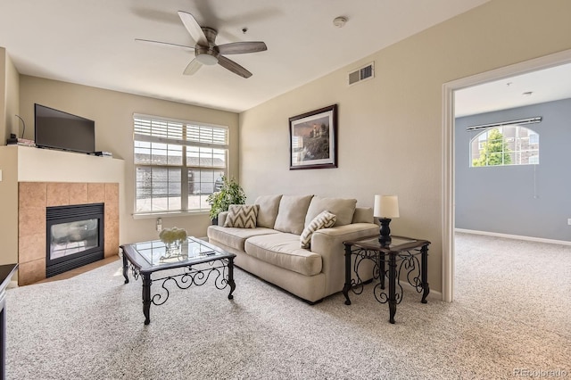 7440 S Blackhawk St Unit 4-102, Englewood, CO 80112 - carpeted living room featuring a ceiling fan, a tile fireplace, and baseboards
