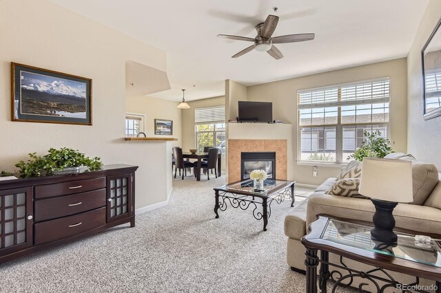 7440 S Blackhawk St Unit 4-102, Englewood, CO 80112 - carpeted living area featuring a ceiling fan, baseboards, and a fireplace