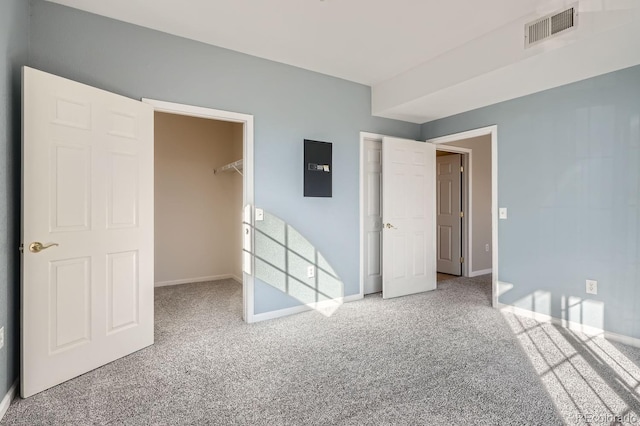 7440 S Blackhawk St Unit 4-102, Englewood, CO 80112 - unfurnished bedroom with carpet flooring, a walk in closet, baseboards, a closet, and electric panel