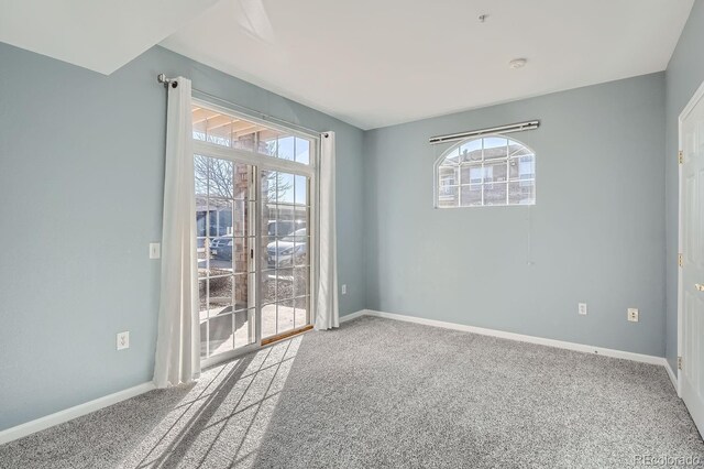 7440 S Blackhawk St Unit 4-102, Englewood, CO 80112 - carpeted empty room featuring plenty of natural light and baseboards