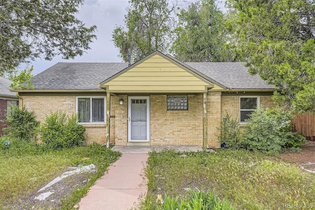 1691 Poplar St, Denver, CO 80220 - view of front of home featuring roof with shingles and brick siding