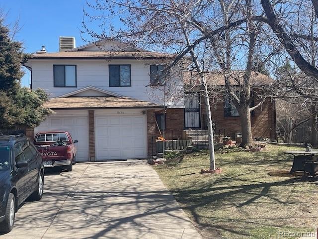 front of property featuring a front lawn and a garage