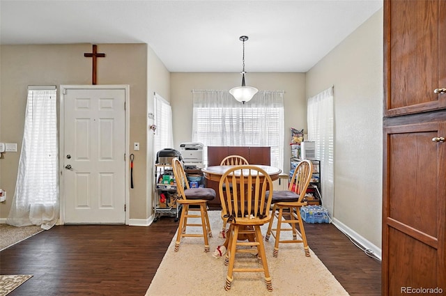 9963 E Carolina Cir Unit 104, Aurora, CO 80247 - dining space featuring dark wood finished floors and baseboards