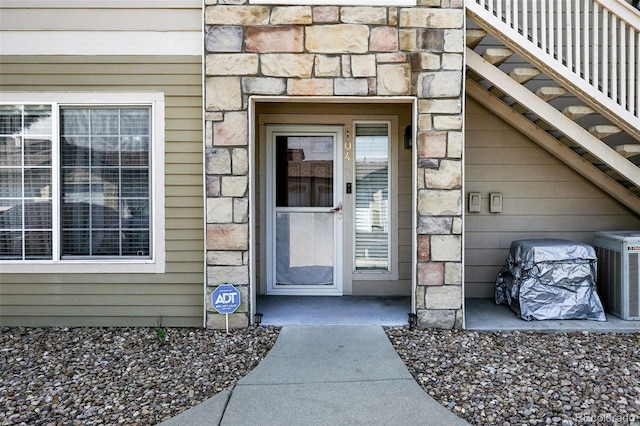 9963 E Carolina Cir Unit 104, Aurora, CO 80247 - property entrance with stone siding and central air condition unit