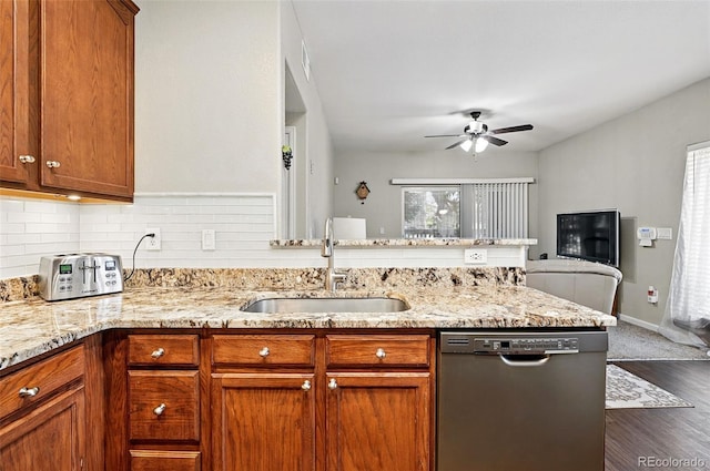 9963 E Carolina Cir Unit 104, Aurora, CO 80247 - kitchen with dishwasher, a sink, a peninsula, ceiling fan, and light stone counters