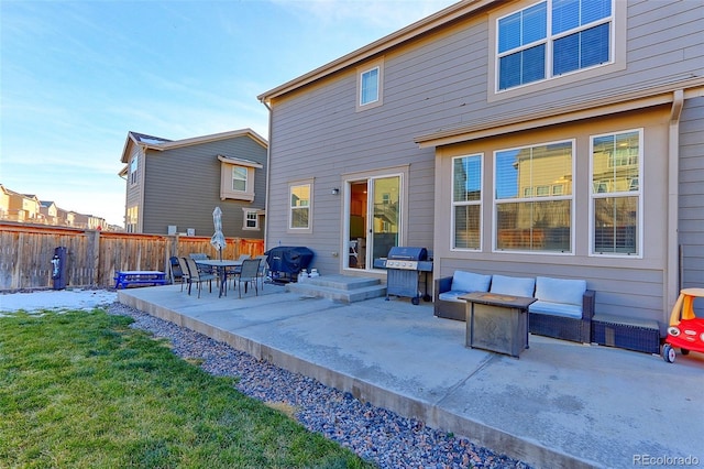 back of property featuring a lawn, an outdoor hangout area, and a patio