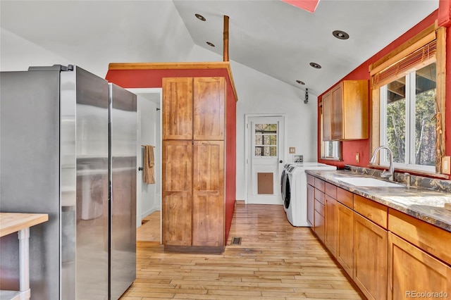 11798 Ridge Rd, Golden, CO 80403 - kitchen with freestanding refrigerator, a sink, light wood-style flooring, lofted ceiling, and brown cabinets