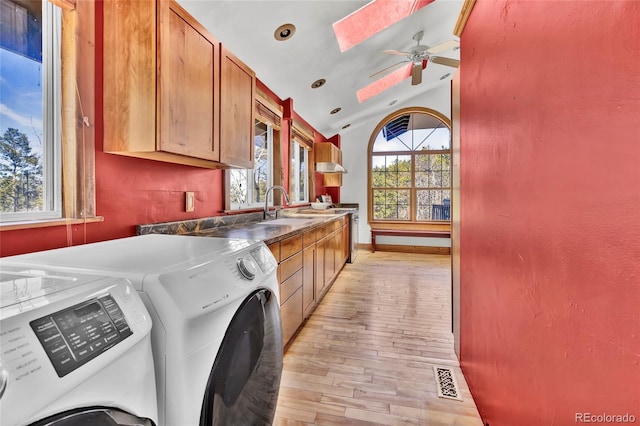 11798 Ridge Rd, Golden, CO 80403 - clothes washing area with washer and dryer, light wood-style floors, cabinet space, a skylight, and a ceiling fan