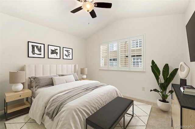 bedroom with light carpet, ceiling fan, baseboards, and vaulted ceiling