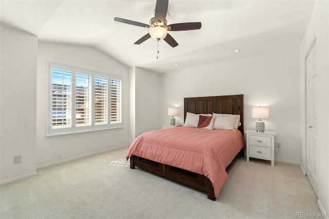 bedroom featuring lofted ceiling, light carpet, baseboards, and a ceiling fan