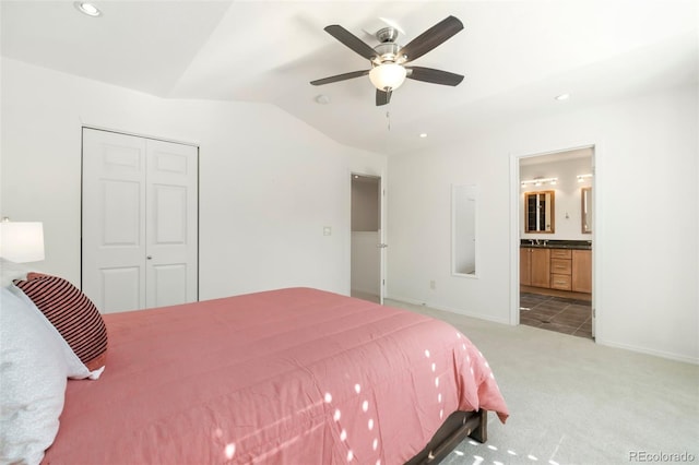 bedroom featuring lofted ceiling, a closet, carpet flooring, and baseboards