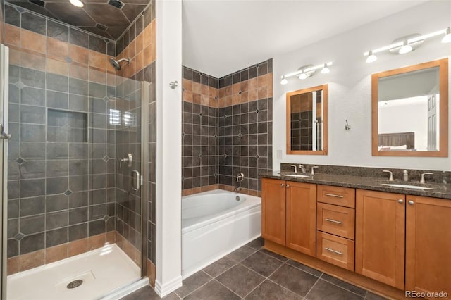 full bathroom with a garden tub, a stall shower, a sink, and tile patterned floors