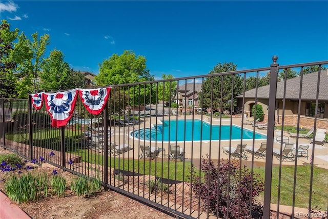 community pool featuring a patio area and fence