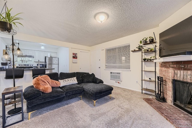 living room featuring a brick fireplace, carpet flooring, and a textured ceiling