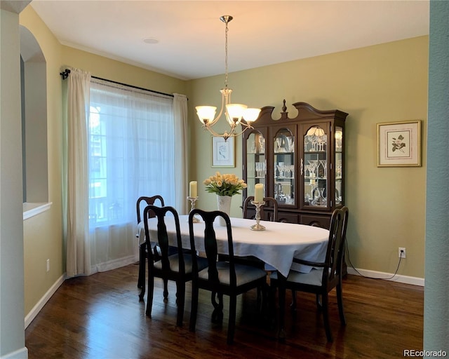 dining room featuring dark hardwood / wood-style floors and a chandelier