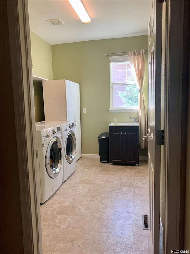 clothes washing area featuring washer and dryer