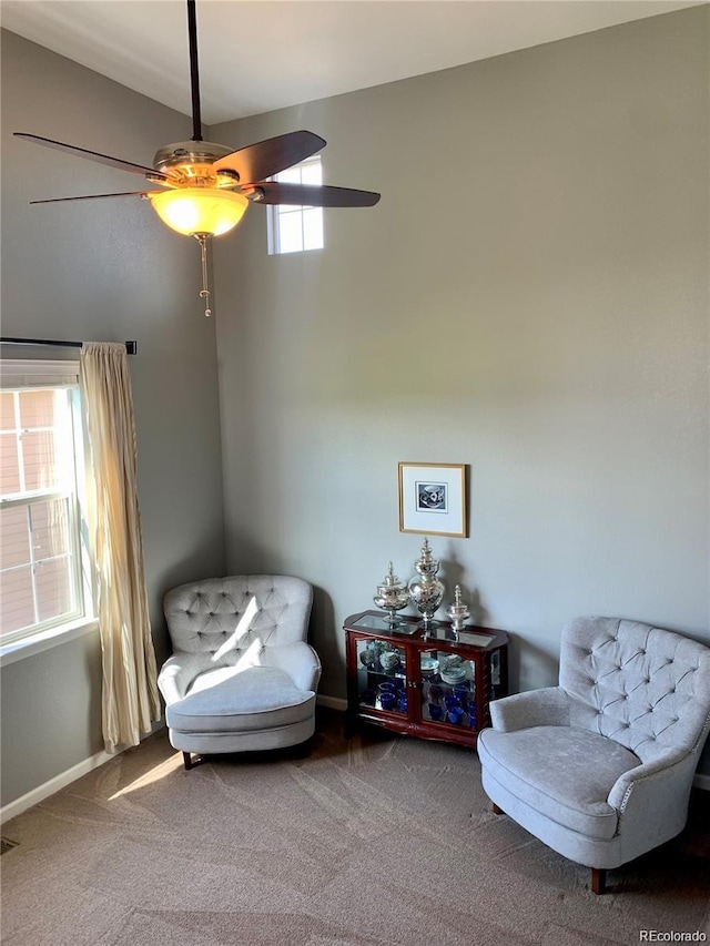 sitting room with ceiling fan and carpet floors