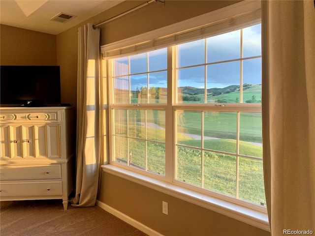 unfurnished bedroom featuring a mountain view and carpet floors