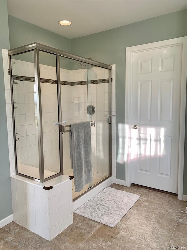 bathroom with a shower with shower door