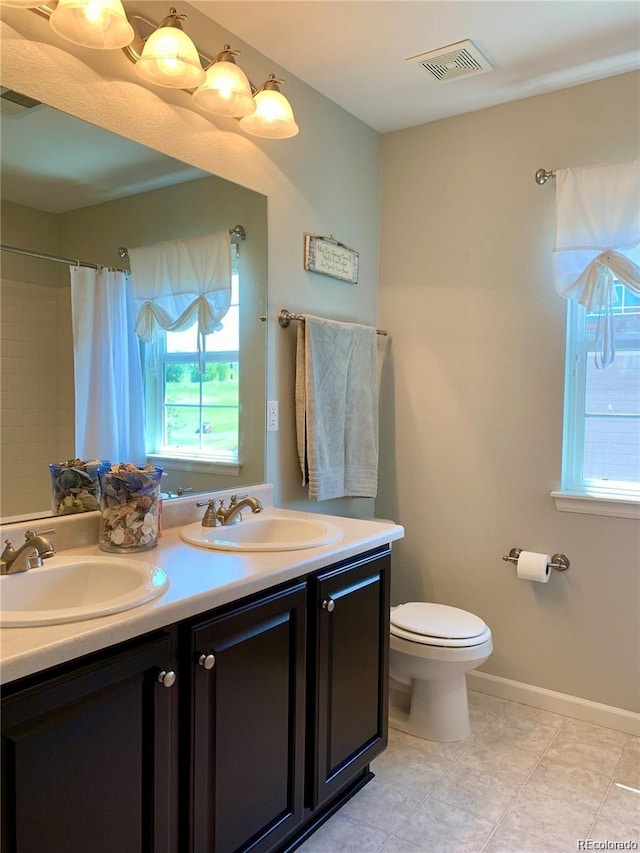 bathroom with vanity, toilet, and walk in shower