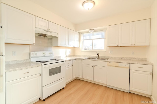 kitchen featuring sink, white appliances, light hardwood / wood-style flooring, and white cabinets