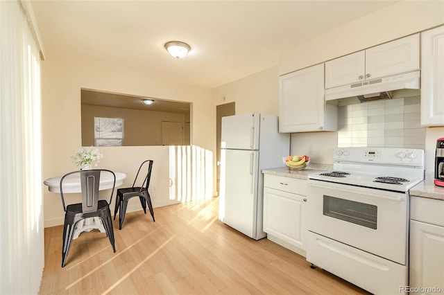 kitchen with white cabinetry, backsplash, white appliances, and light hardwood / wood-style flooring