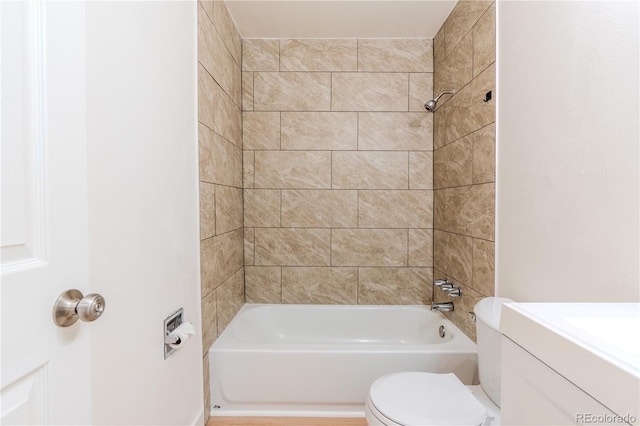 full bathroom with vanity, tiled shower / bath combo, and toilet