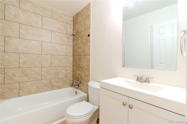 full bathroom with tiled shower / bath combo, vanity, and toilet