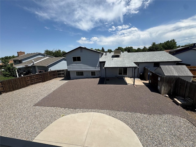 2493 S Kalispell Cir, Aurora, CO 80013 - rear view of property featuring a patio, a fenced backyard, and roof with shingles