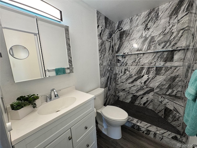 2493 S Kalispell Cir, Aurora, CO 80013 - full bath with vanity, a tile shower, and wood finished floors