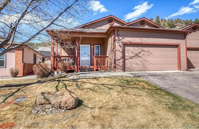 ranch-style house with covered porch, driveway, and an attached garage