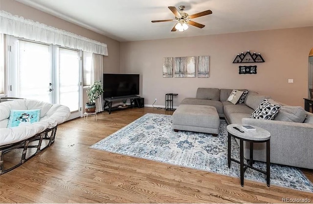 living area featuring ceiling fan and wood finished floors