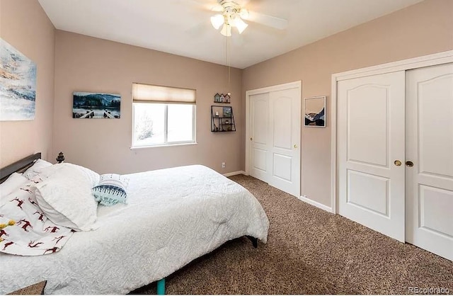 carpeted bedroom featuring a ceiling fan, baseboards, and two closets