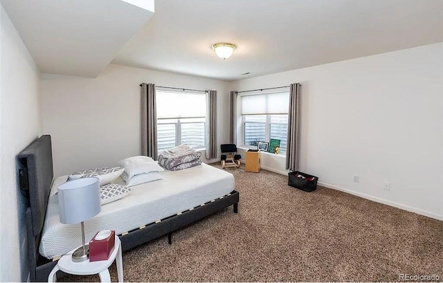 carpeted bedroom featuring baseboards