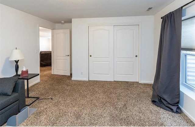 interior space featuring a closet, visible vents, and baseboards