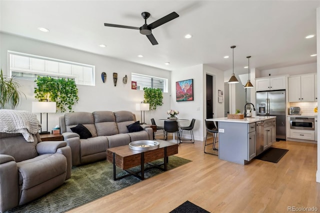 1299 Newton St, Denver, CO 80204 - living area with a ceiling fan, light wood-style floors, and recessed lighting