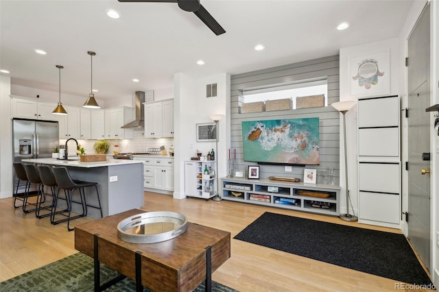 1299 Newton St, Denver, CO 80204 - living area with a ceiling fan, light wood finished floors, and recessed lighting
