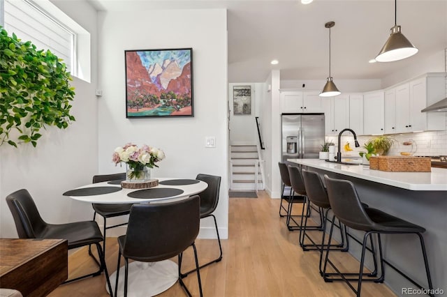 1299 Newton St, Denver, CO 80204 - dining room with light wood-type flooring, recessed lighting, and stairs
