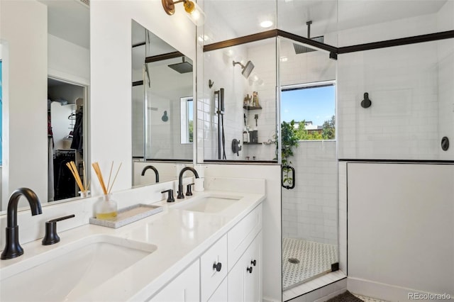 1299 Newton St, Denver, CO 80204 - full bathroom featuring a shower stall and double vanity