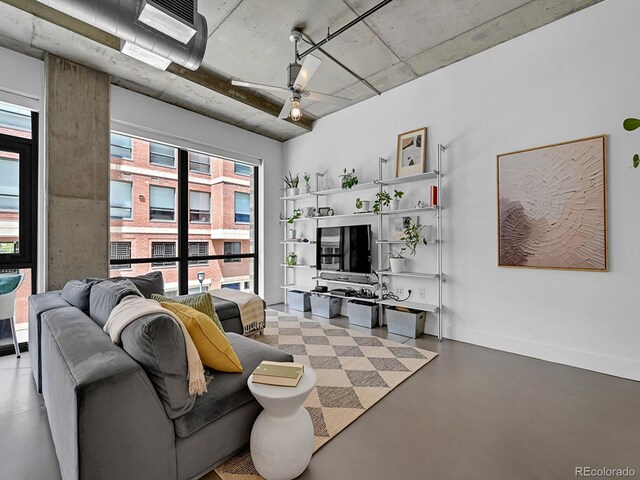 living room featuring concrete floors and baseboards