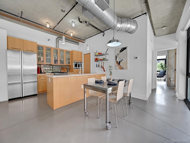 dining area featuring concrete floors and baseboards